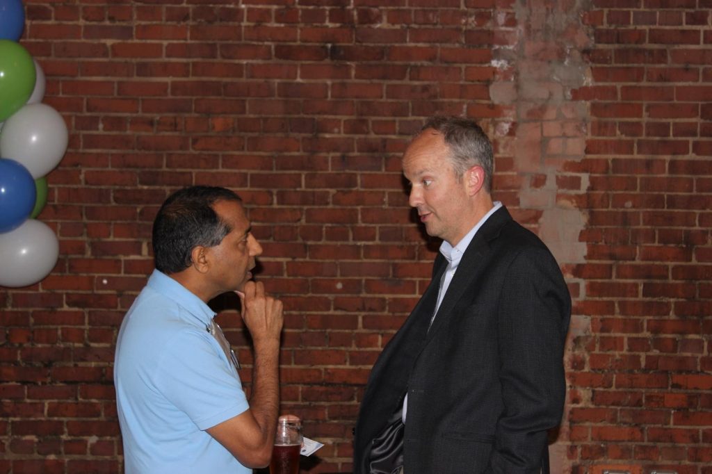 Mark Schoenfisch (right) meets with colleagues during the Celebration of Inventorship reception