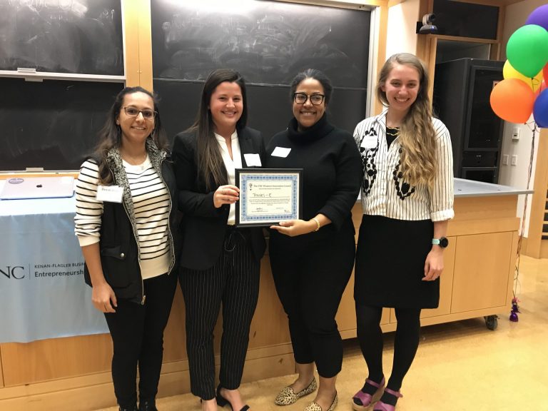Doctoral student Denali Dahl (left) from the UNC Women's Innovation Council presents the Travel-E team with an award for the best women-founded venture